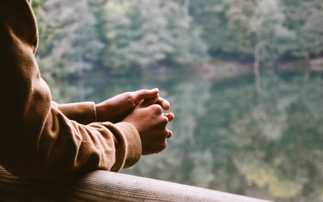 person leaning against railing